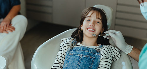 Young child lying in a dental chair during a dental exam with the dentist