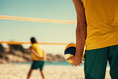 Team of young australian athletes playing beach volleyball on coastal sand court