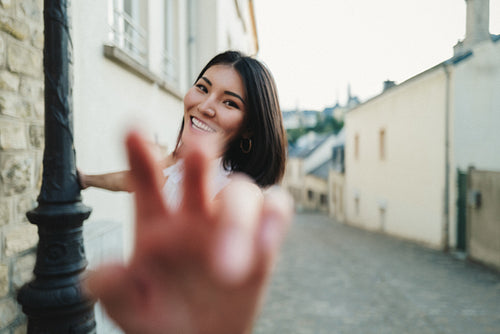 Candid portrait of playful woman in the streets of a European capital