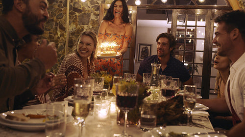 Friends celebrating birthday with cake