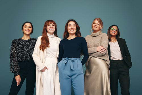 Smiling women fo different ages standing together