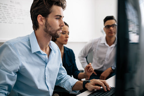 Application developers working on computers in office