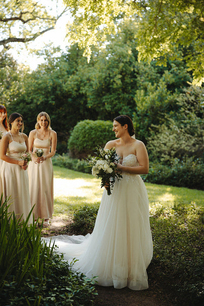 Beautiful bride with bridesmaids enjoying a garden wedding