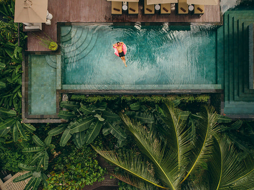 Young man relaxing in resort swimming pool