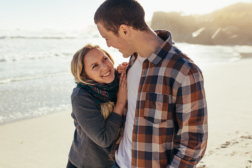 Loving couple standing outdoors at the beach