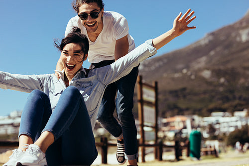 Couple enjoying themselves with a skateboard