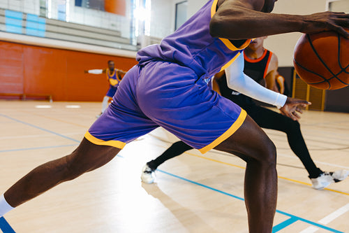 Basketball players competing on indoor court