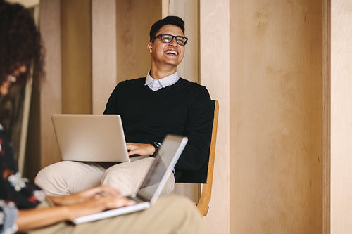 Business colleagues working on laptops in office