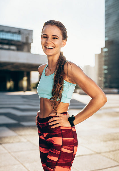 Sportswoman smiling outdoors in morning