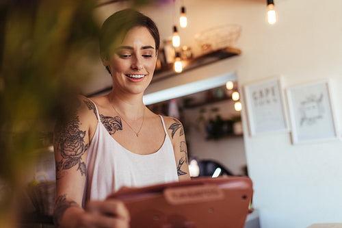 Woman entrepreneur at the billing counter of her restaurant