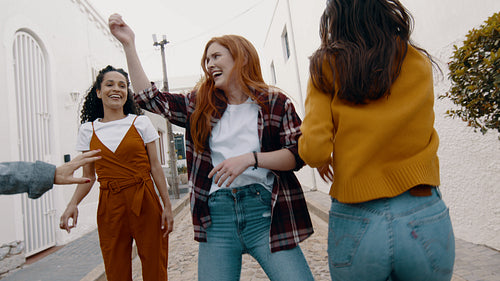 Group of women dancing and having fun outdoors