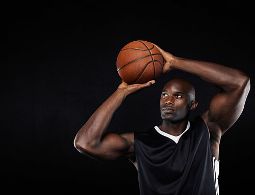 Young african male shooting at the hoop