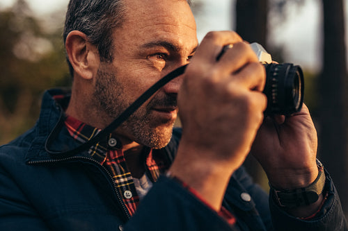 Photographer taking a photo outdoors