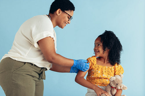 Doctor giving vaccine to small patient