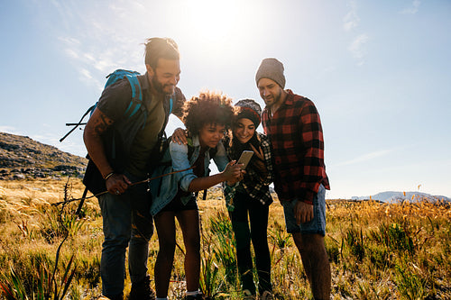 African female with friends taking pictures in countryside