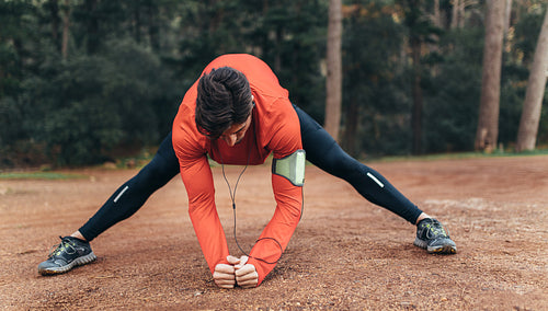 Man exercising in a park listening to music