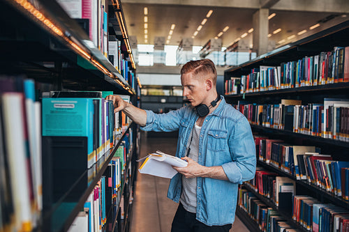 Handsome college student in library