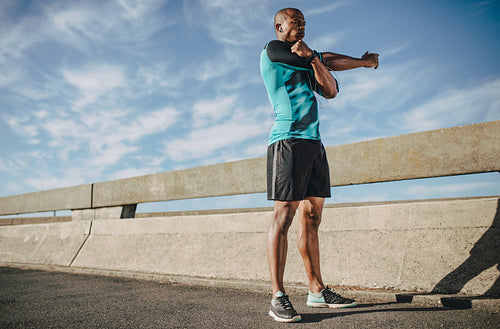 Male athlete warming up before a run