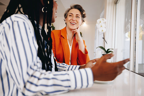 Smiling businesswomen having a discussion during a coffee meeting in a cafe