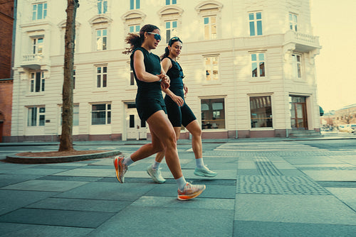 Woman-focused running in the city captures a social outdoor fitness moment