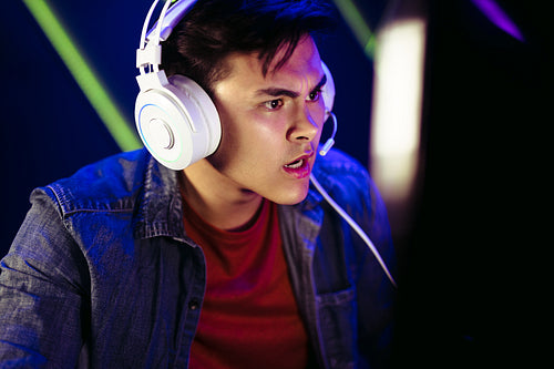 Shocked gamer looking at the computer screen during an online gaming session