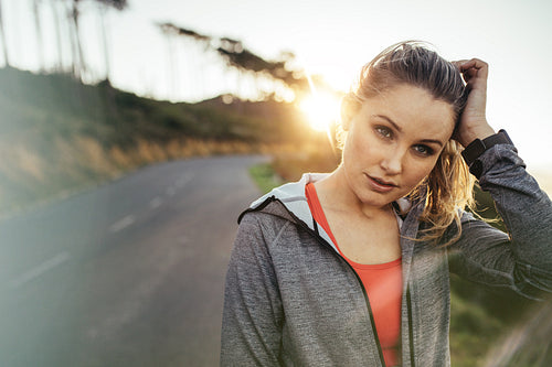 Portrait of a female athlete walking on street