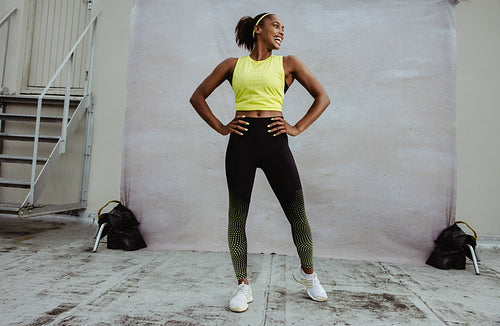 African woman in fitness wear on rooftop