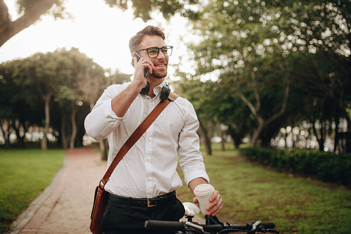 Businessman talking on mobile phone standing in street