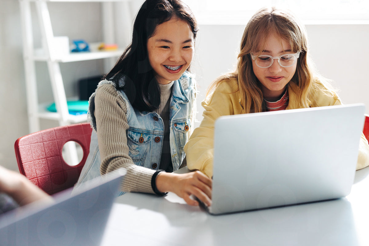 Working together to build a foundation in computer science, young girl ...