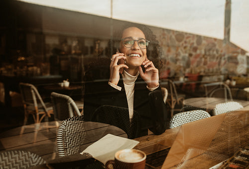 Woman using a mobile phone in a cafe