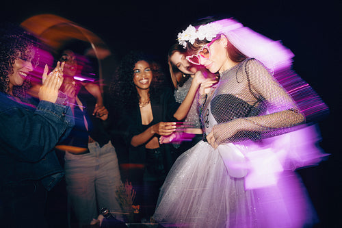 Bride-to-be enjoying a vibrant party with friends in celebratory mood
