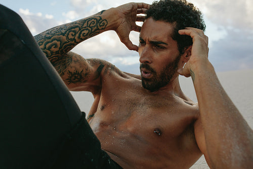 Muscular man doing sit-ups outdoors