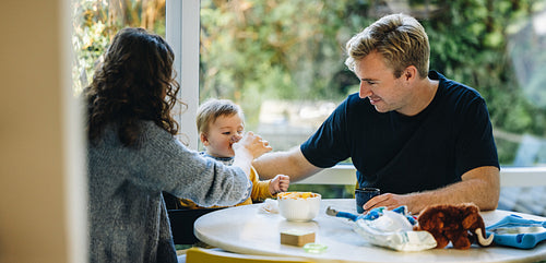 Parents taking care of their newborn baby at home