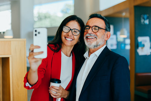 Senior managers taking a selfie together at the office