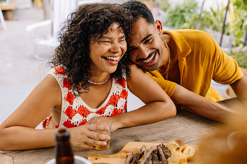 Brazilian couple laughing together while eating churrasco in Rio de Janeiro