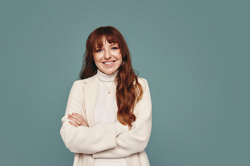 Pretty young woman smiling cheerfully in a studio