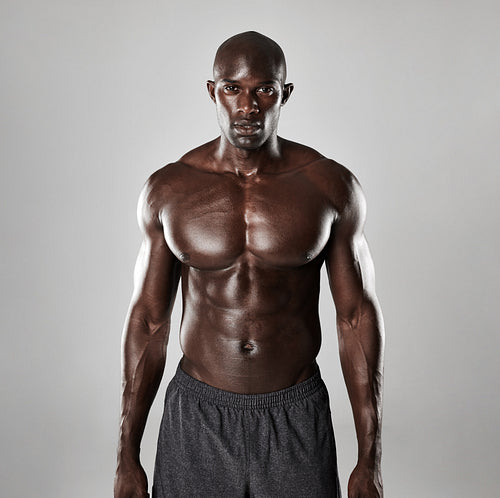 Shirtless male model  standing confidently