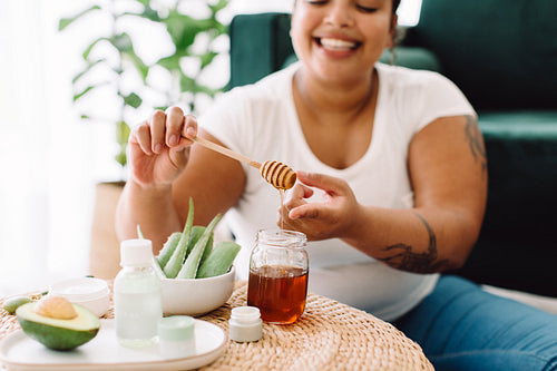 Woman using honey for beauty care