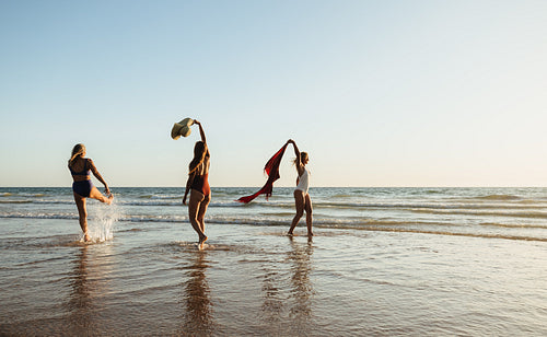 Playful moment at the beach during a beautiful sunset