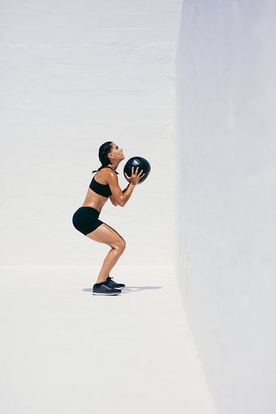 Fitness woman doing exercises using a medicine ball