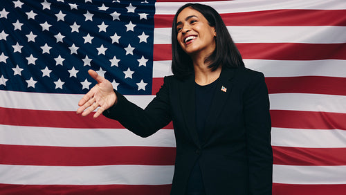 Happy American politician holding out her hand for a handshake