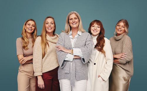 Cheerful women of different ages standing together