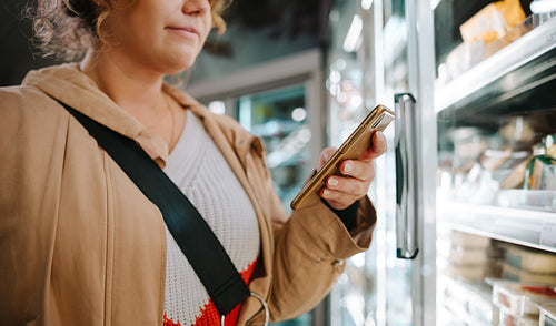 Shopper looking at the grocery list on her phone