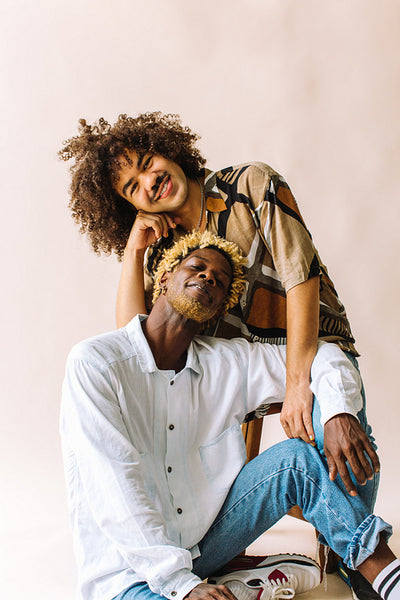 Happy gay couple posing in a studio