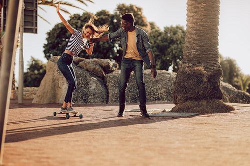 Woman learning to ride long board