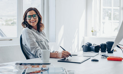 Professional photographer at her office desk