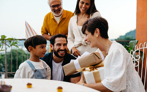Family celebrates a birthday with a joyful outdoor gathering