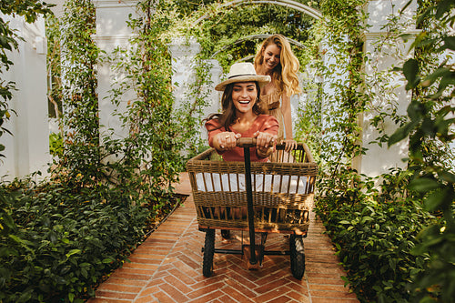 Best friends playing with a trolley cart