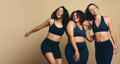 Celebrating fitness: Female friends smiling in sports clothing