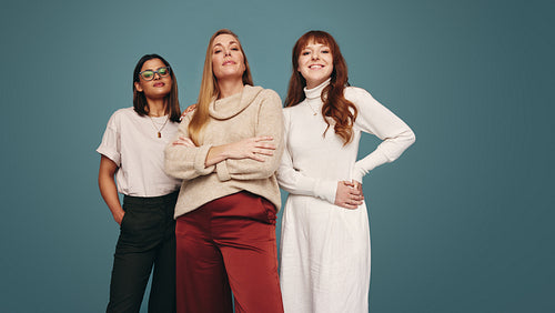 Cheerful women of different ages looking at the camera